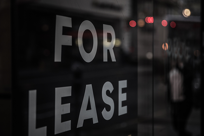 'For Lease' sign in a commercial space